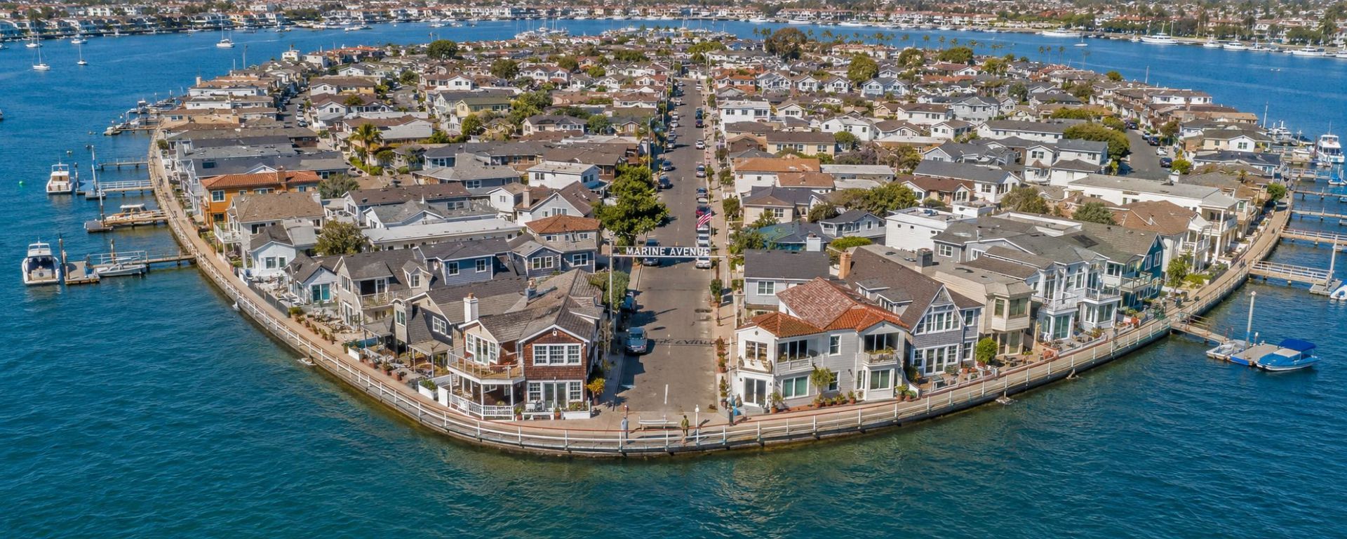 Aerial view of Balboa Island's perimeter boardwalk and harbor cottages, Newport Beach